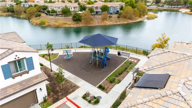 an aerial view of a residential houses with outdoor space and river