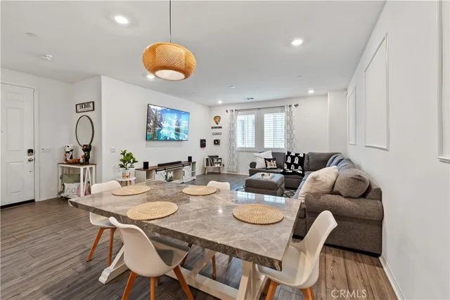 a view of a dining room with furniture and wooden floor