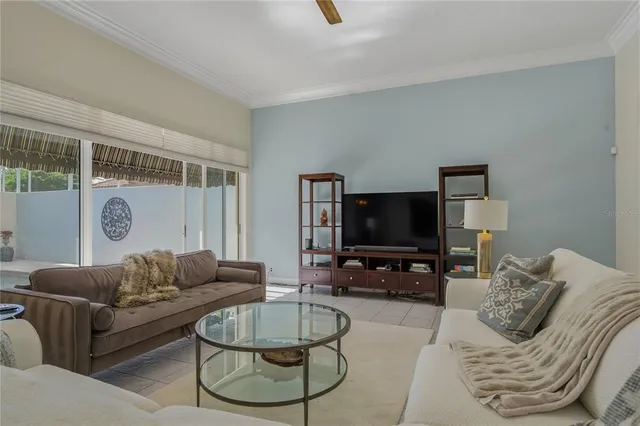 a view of a dining room with furniture a chandelier and wooden floor