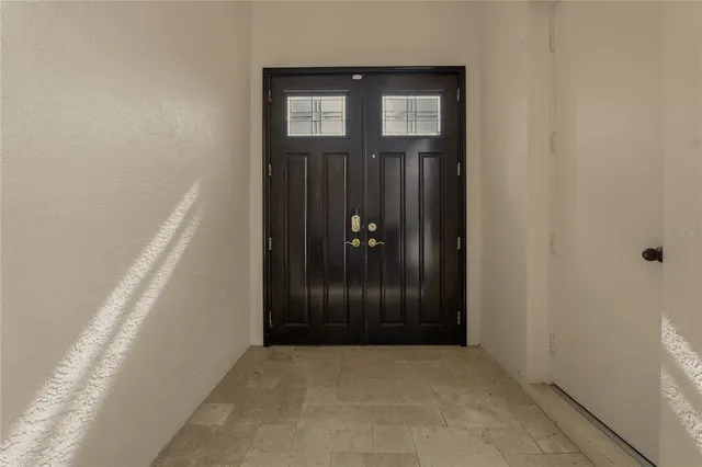 a kitchen with stainless steel appliances a sink a stove a refrigerator cabinets and a dining table