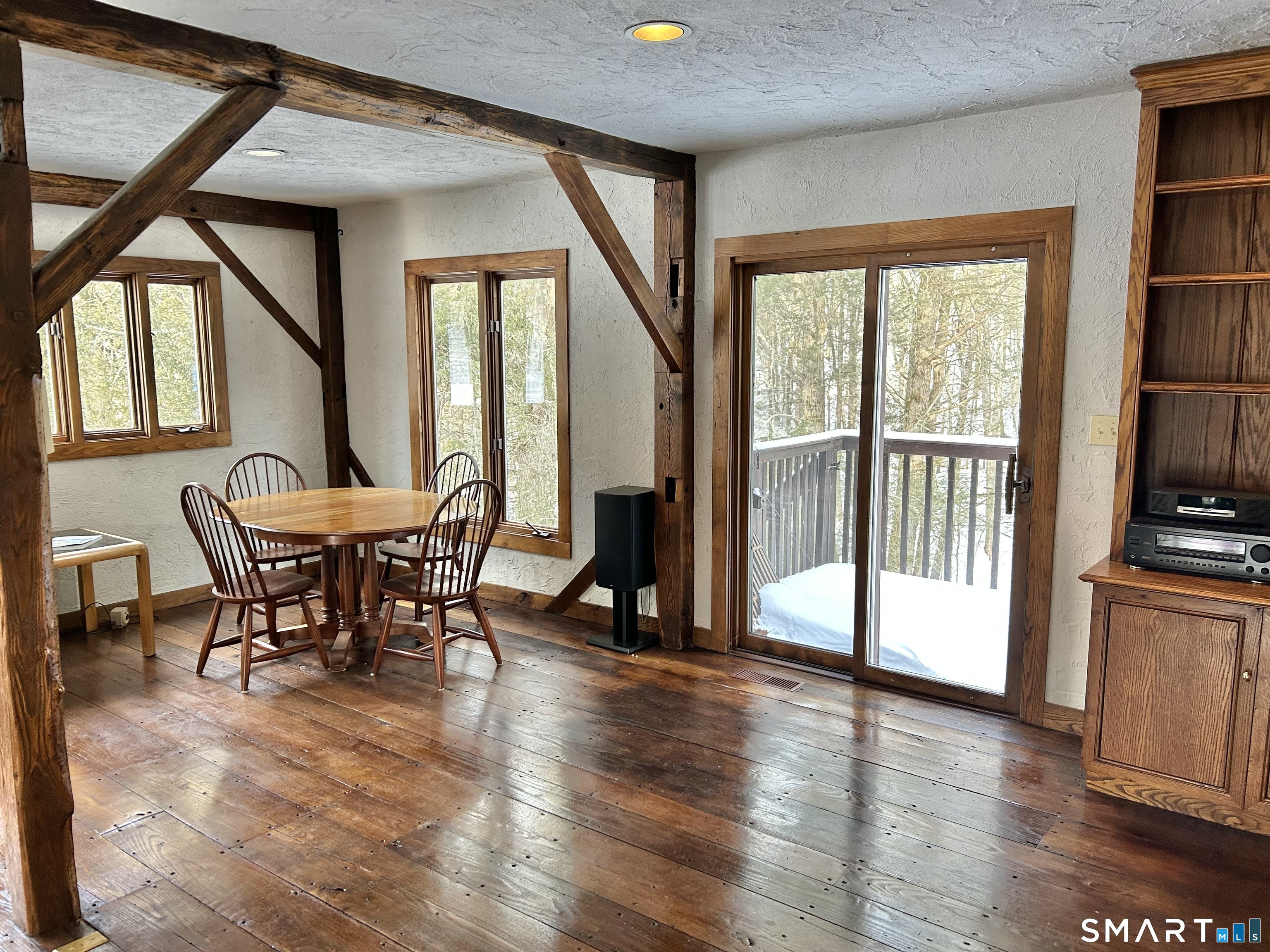 Family Room offers a kitchen table with a slider leading to deck and sounds of a babbling brook.