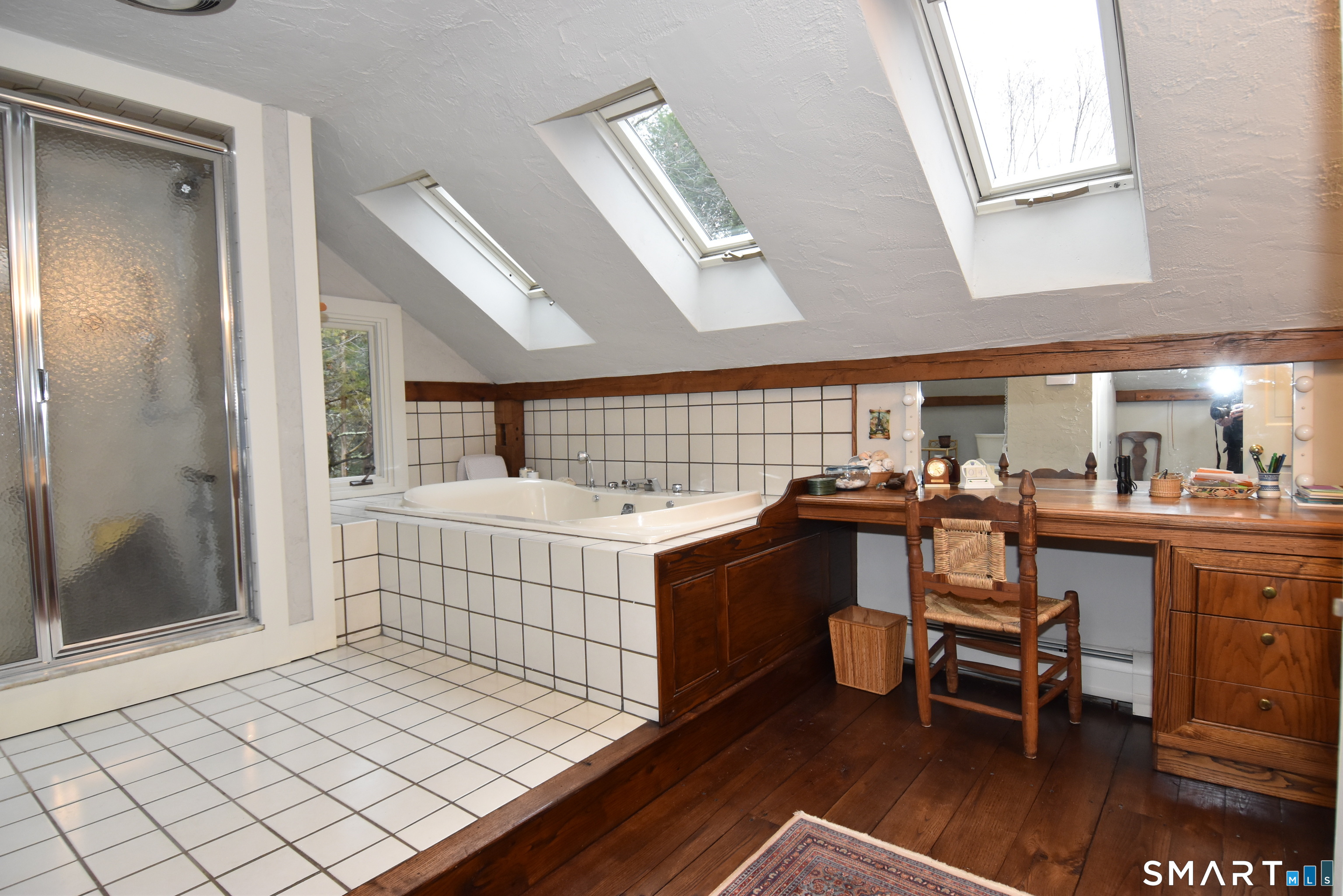 148 Flanders Road Woodbury, CT 06798 - Photo 12 of 16 a room with lots of wooden furniture and a window