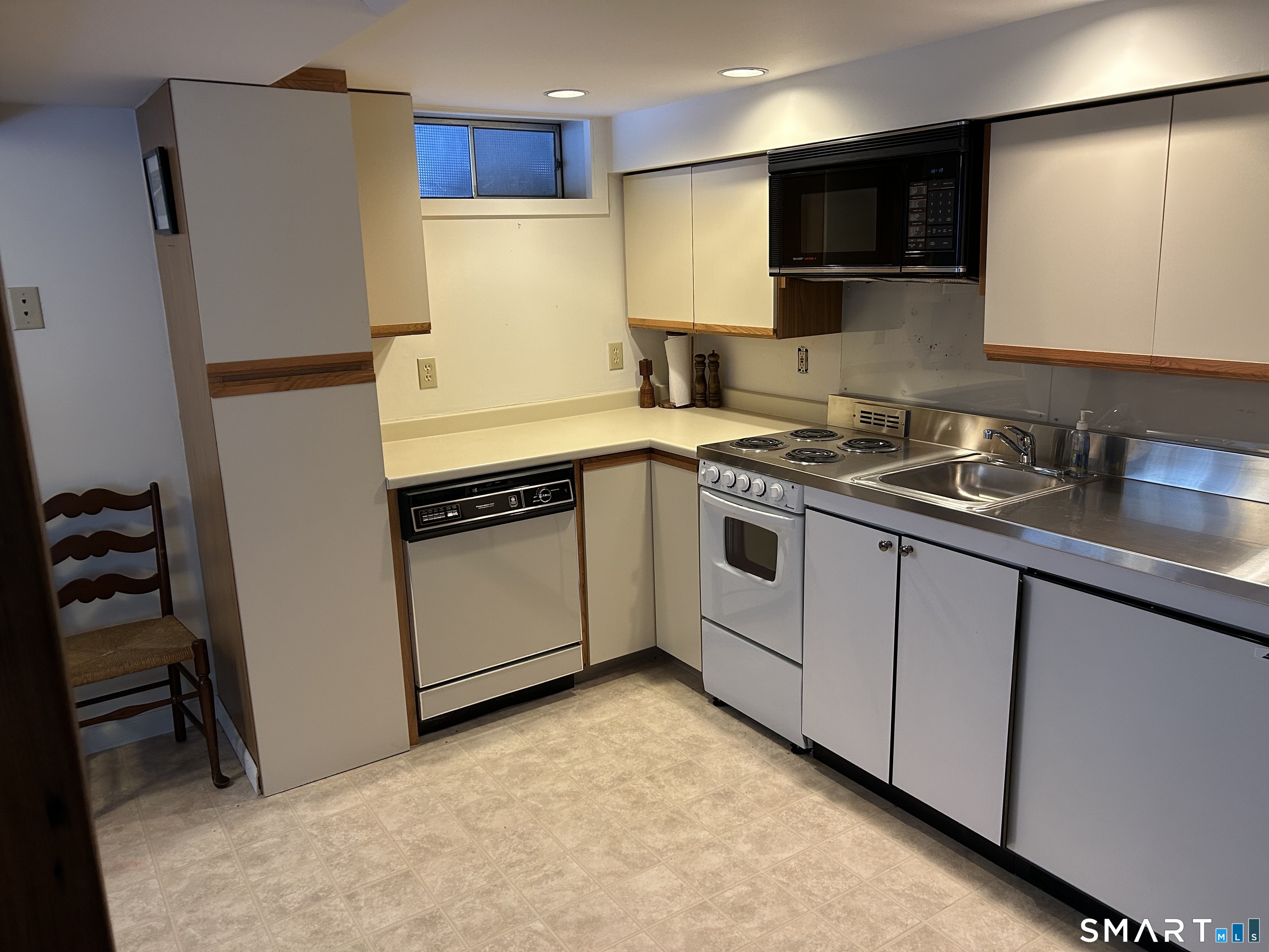 148 Flanders Road Woodbury, CT 06798 - Photo 16 of 16 a kitchen with stainless steel appliances a refrigerator sink and microwave