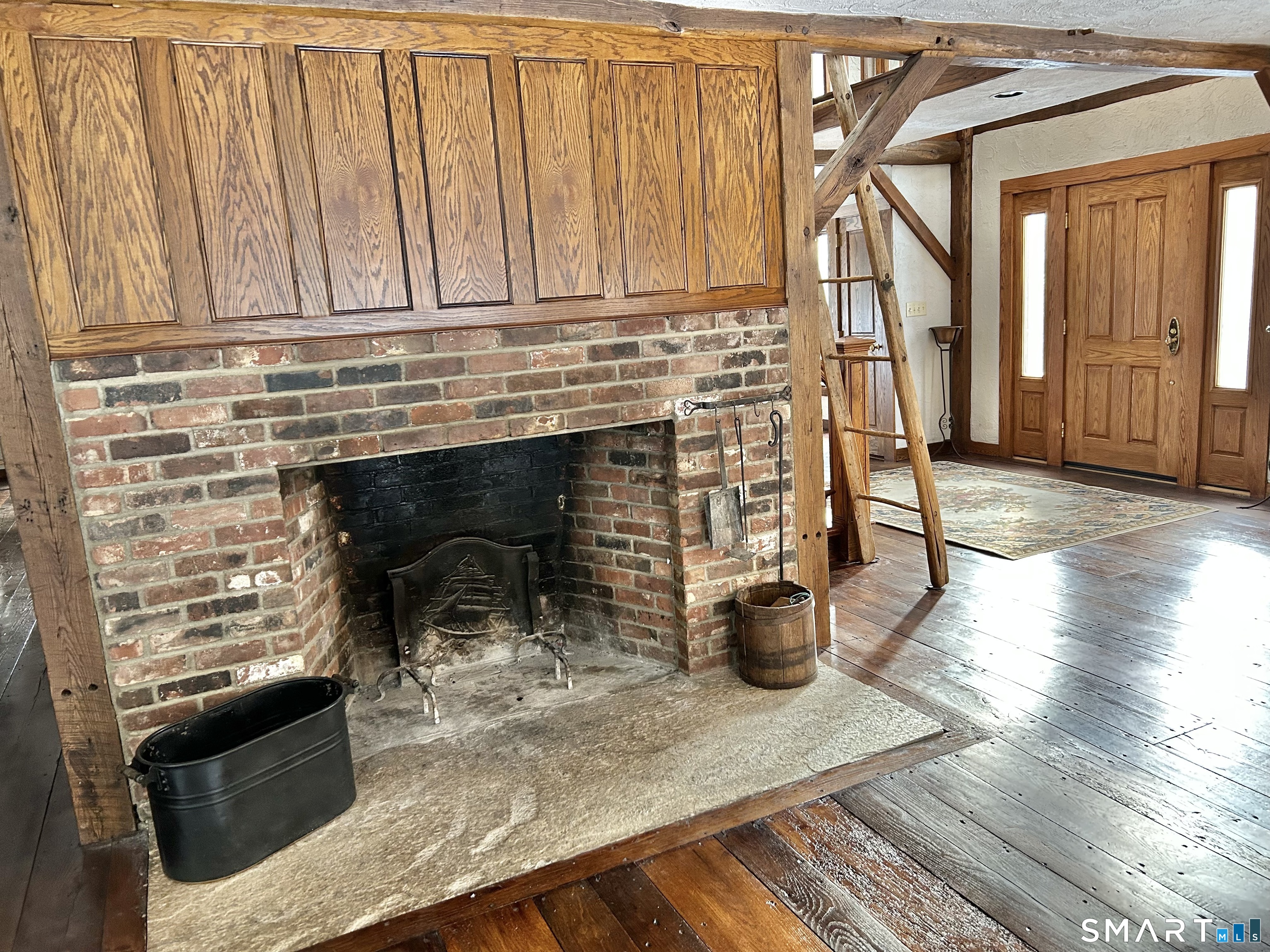 148 Flanders Road Woodbury, CT 06798 - Photo 2 of 16 Masonary Wood Burning Fireplace is locate in the Kitchen/Family Room area.