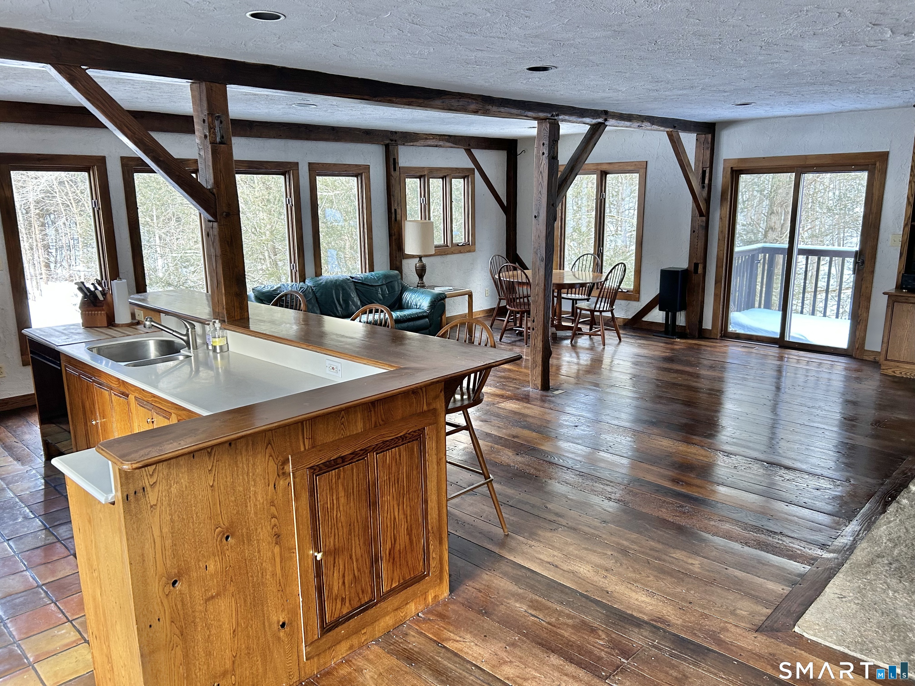 148 Flanders Road Woodbury, CT 06798 - Photo 3 of 16 a room with wooden floor table and chairs