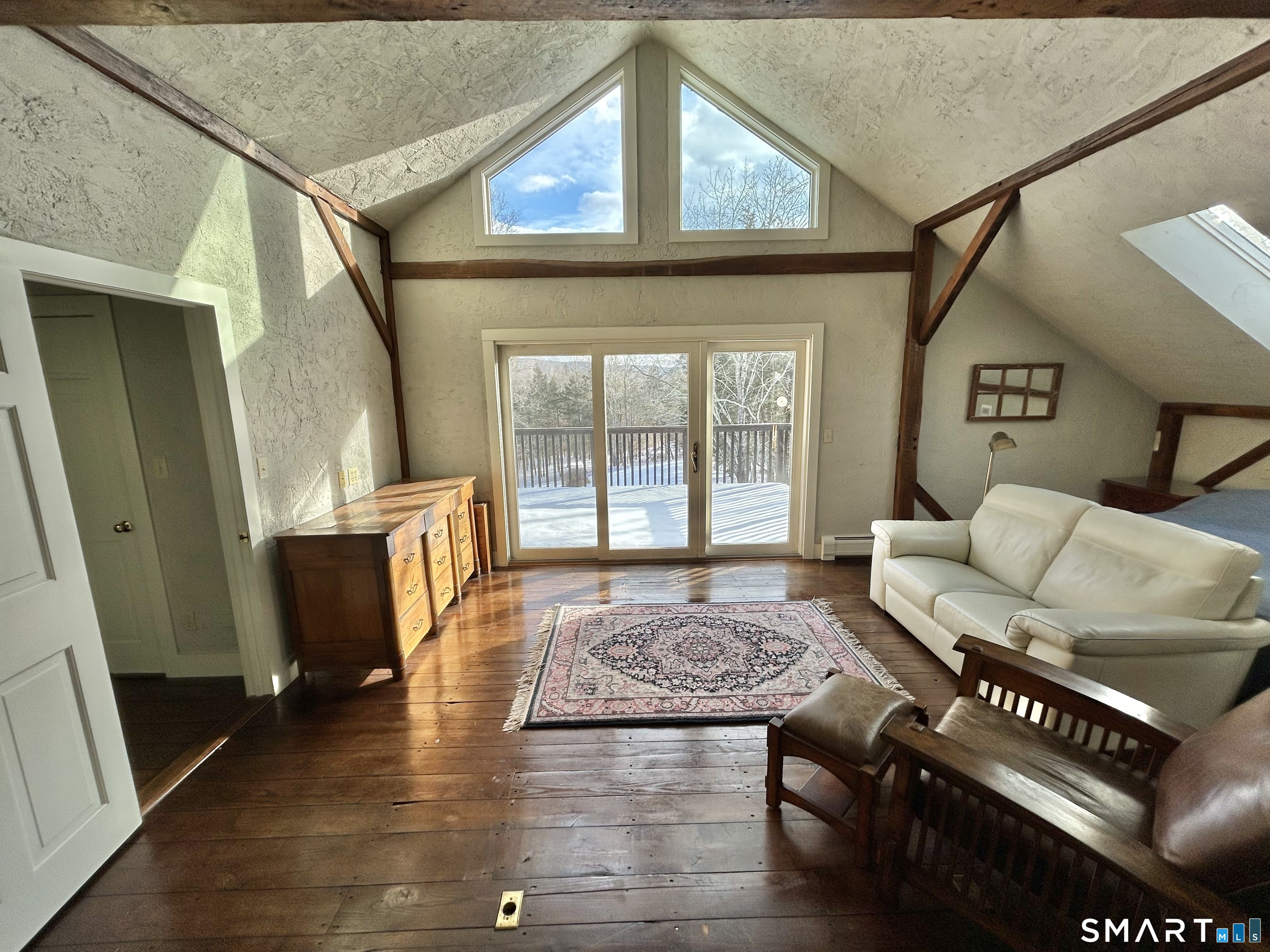 148 Flanders Road Woodbury, CT 06798 - Photo 10 of 16 a living room with furniture and a gate