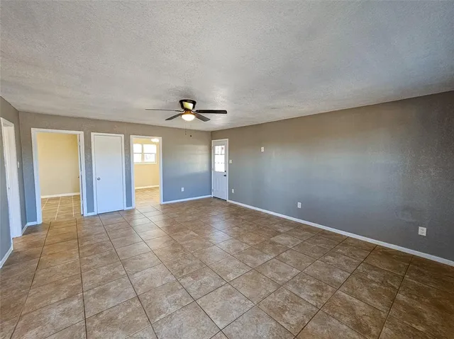 an empty room with a empty space and windows