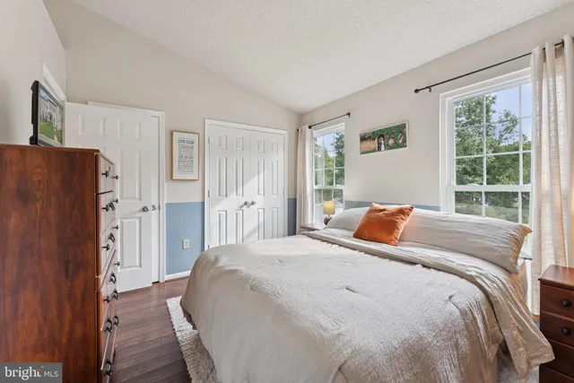 a bed sitting in a bedroom next to a window