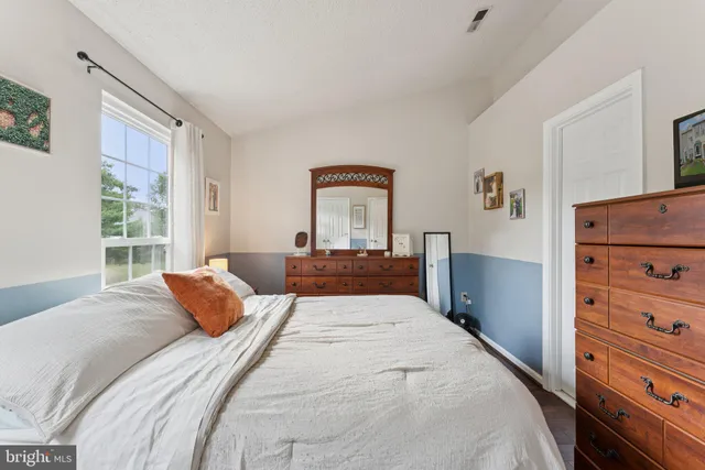 a bedroom with a large bed and a window