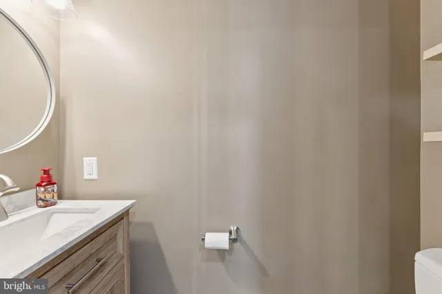 a bathroom with a sink vanity and a mirror
