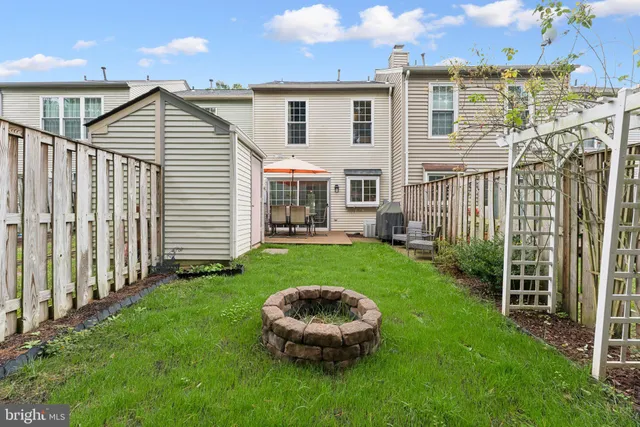 a front view of a house with a yard table and chairs
