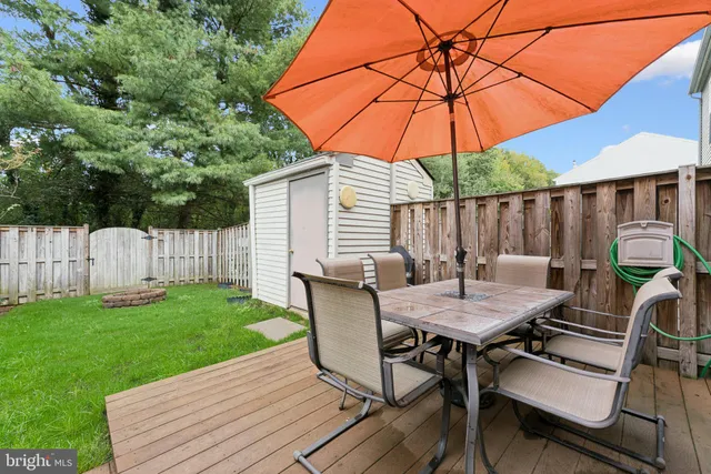 a view of a patio with a table and chairs under an umbrella