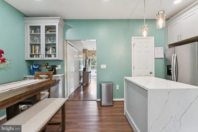 a kitchen with stainless steel appliances a refrigerator and a stove top oven