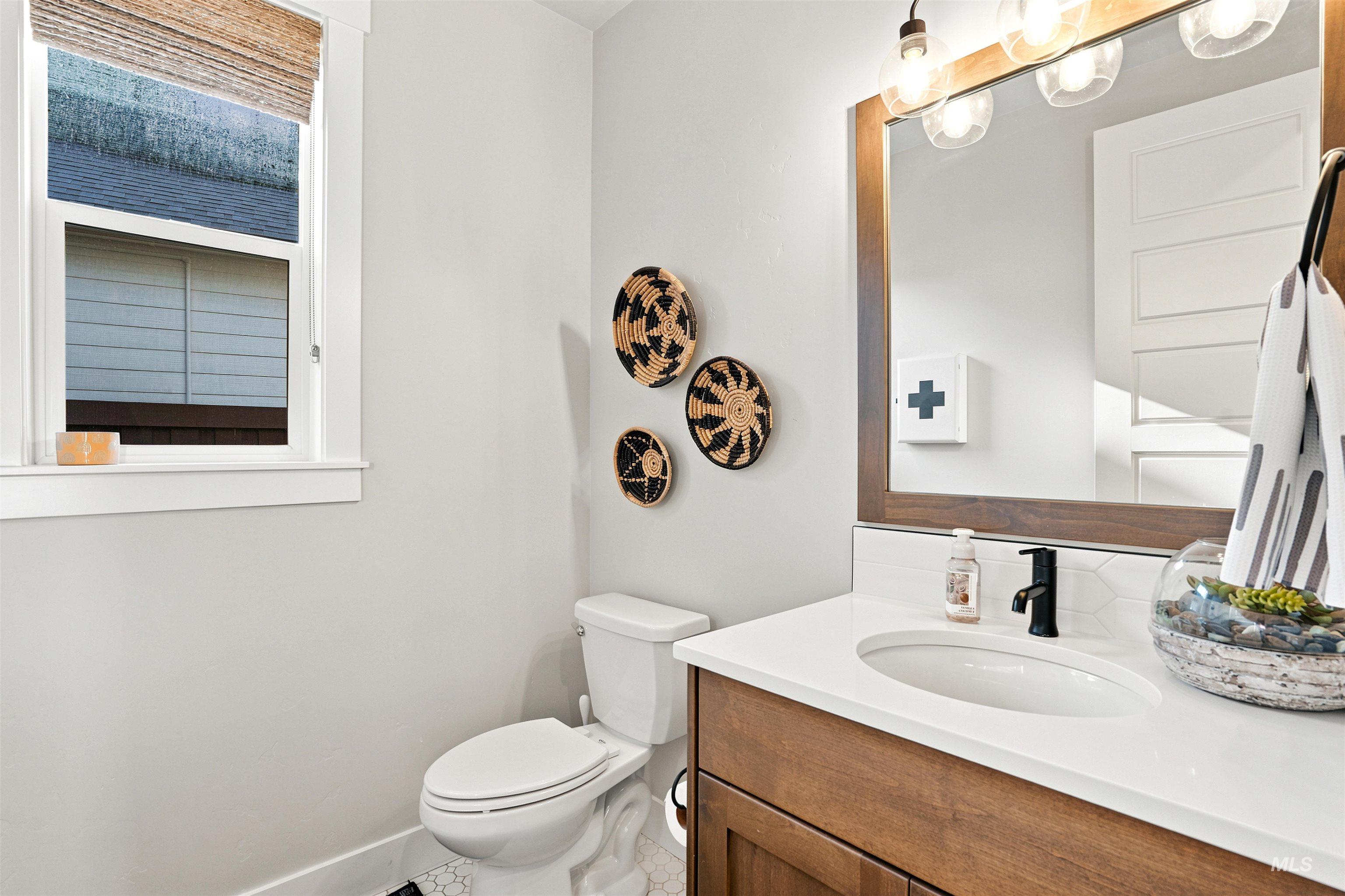 4323 West Ladle Rpds Drive Meridian, ID 83646 - Photo 39 of 49 Vanity with wood-finish cabinetry, white countertop, and integrated sink