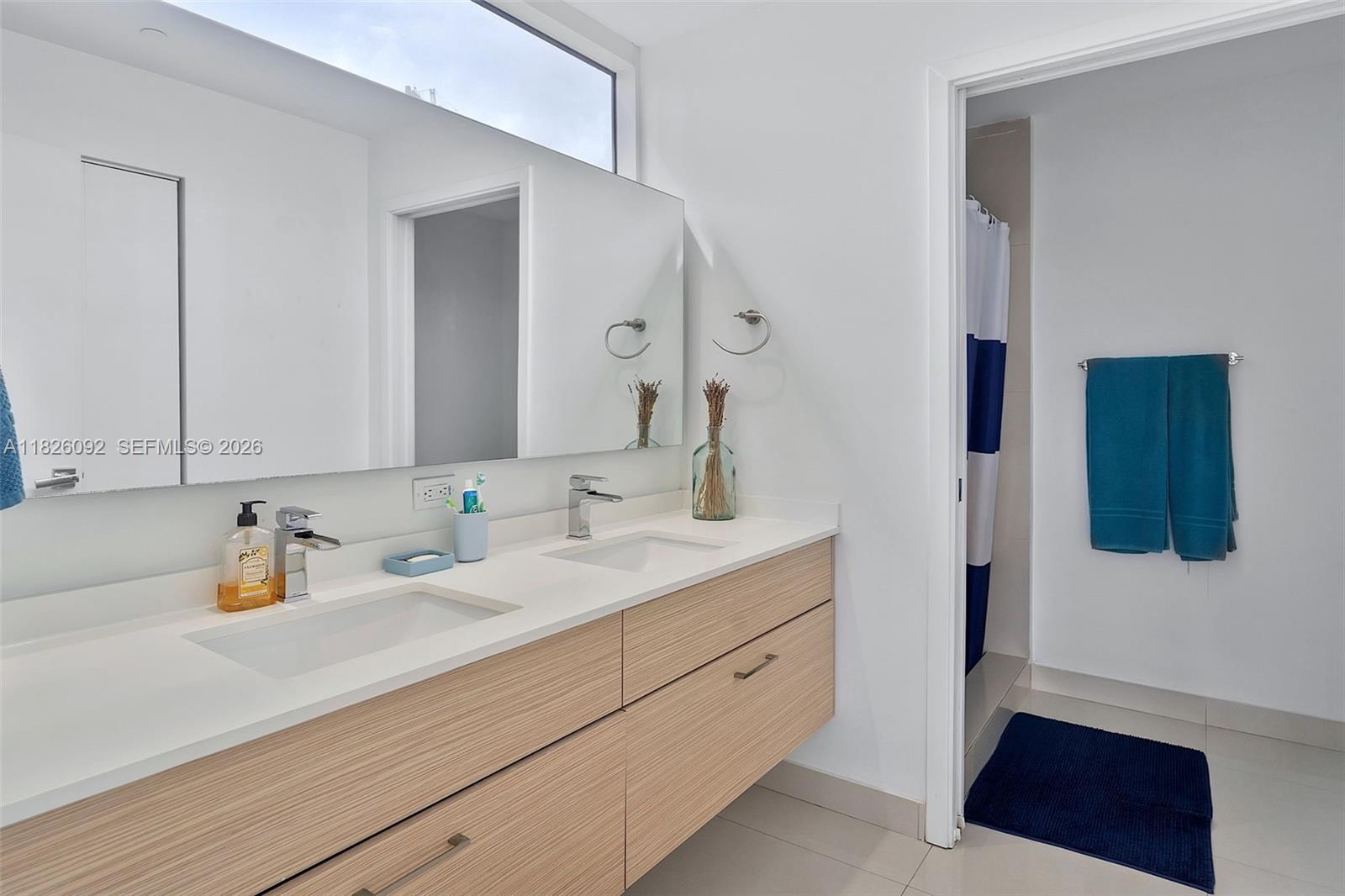 600 Northeast 27th Street, Unit 1105 Miami, FL 33137 - Photo 38 of 100 a bathroom with a sink and a mirror