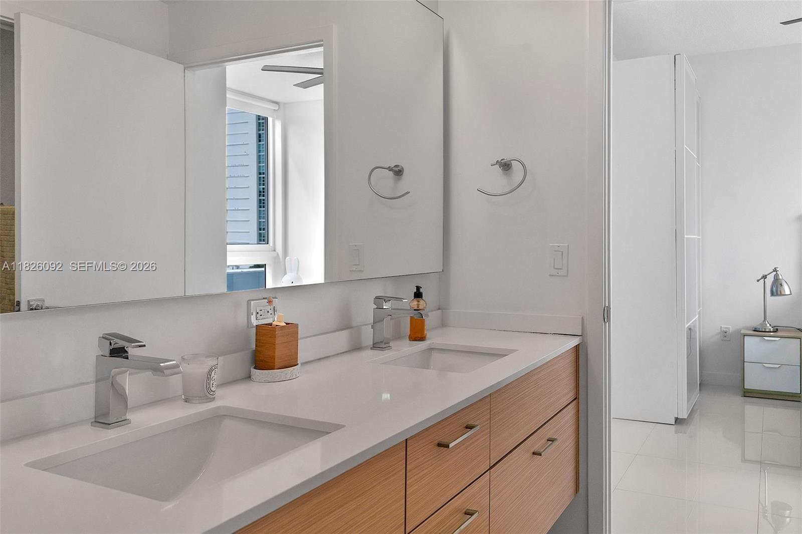 600 Northeast 27th Street, Unit 1105 Miami, FL 33137 - Photo 39 of 100 a bathroom with a sink and a mirror