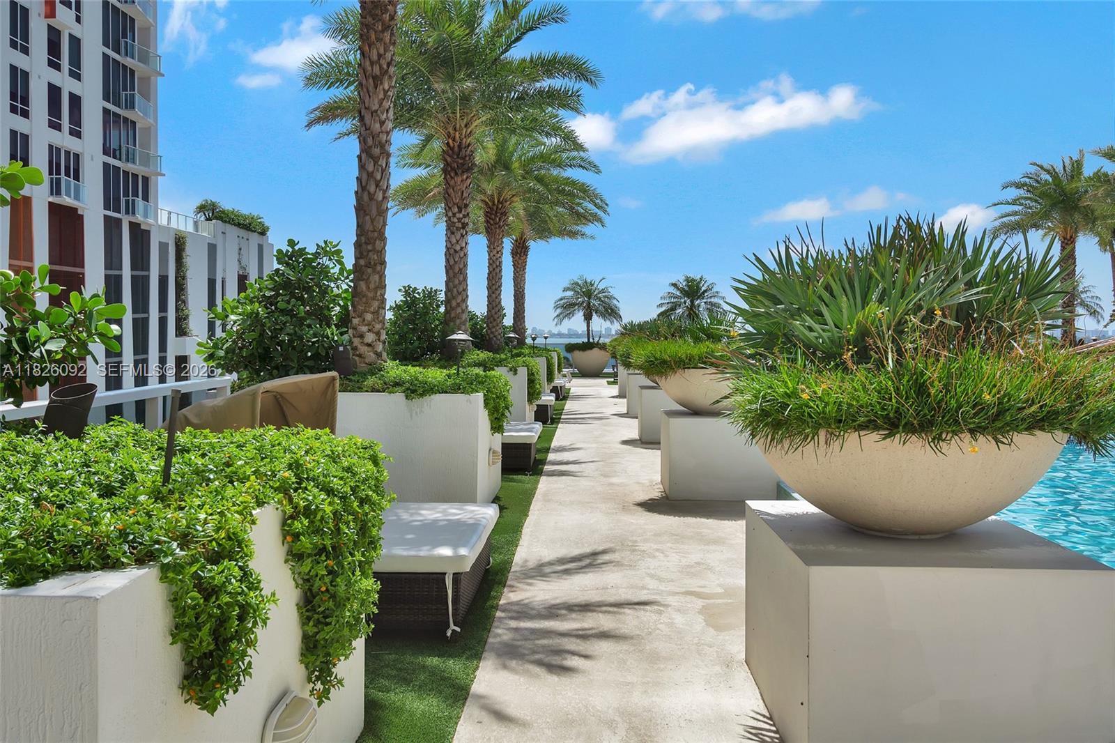 600 Northeast 27th Street, Unit 1105 Miami, FL 33137 - Photo 5 of 100 a view of a white building with a potted plants and palm trees