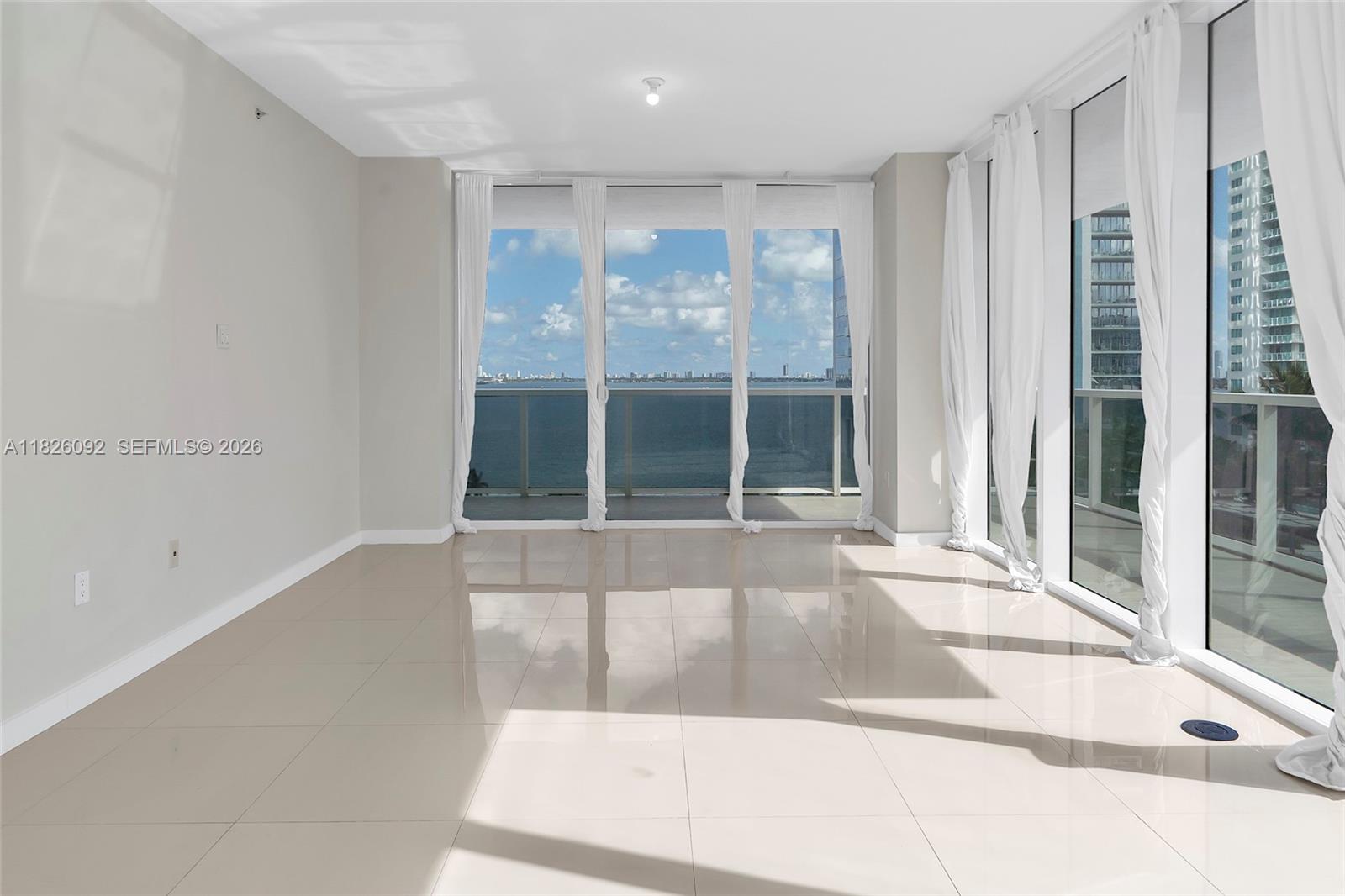 600 Northeast 27th Street, Unit 1105 Miami, FL 33137 - Photo 54 of 100 a view of an empty room with wooden floor and windows