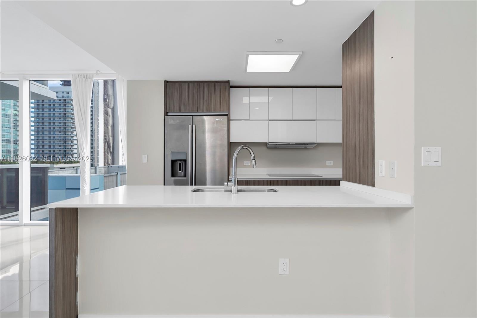 600 Northeast 27th Street, Unit 1105 Miami, FL 33137 - Photo 70 of 100 a kitchen with a refrigerator and a sink