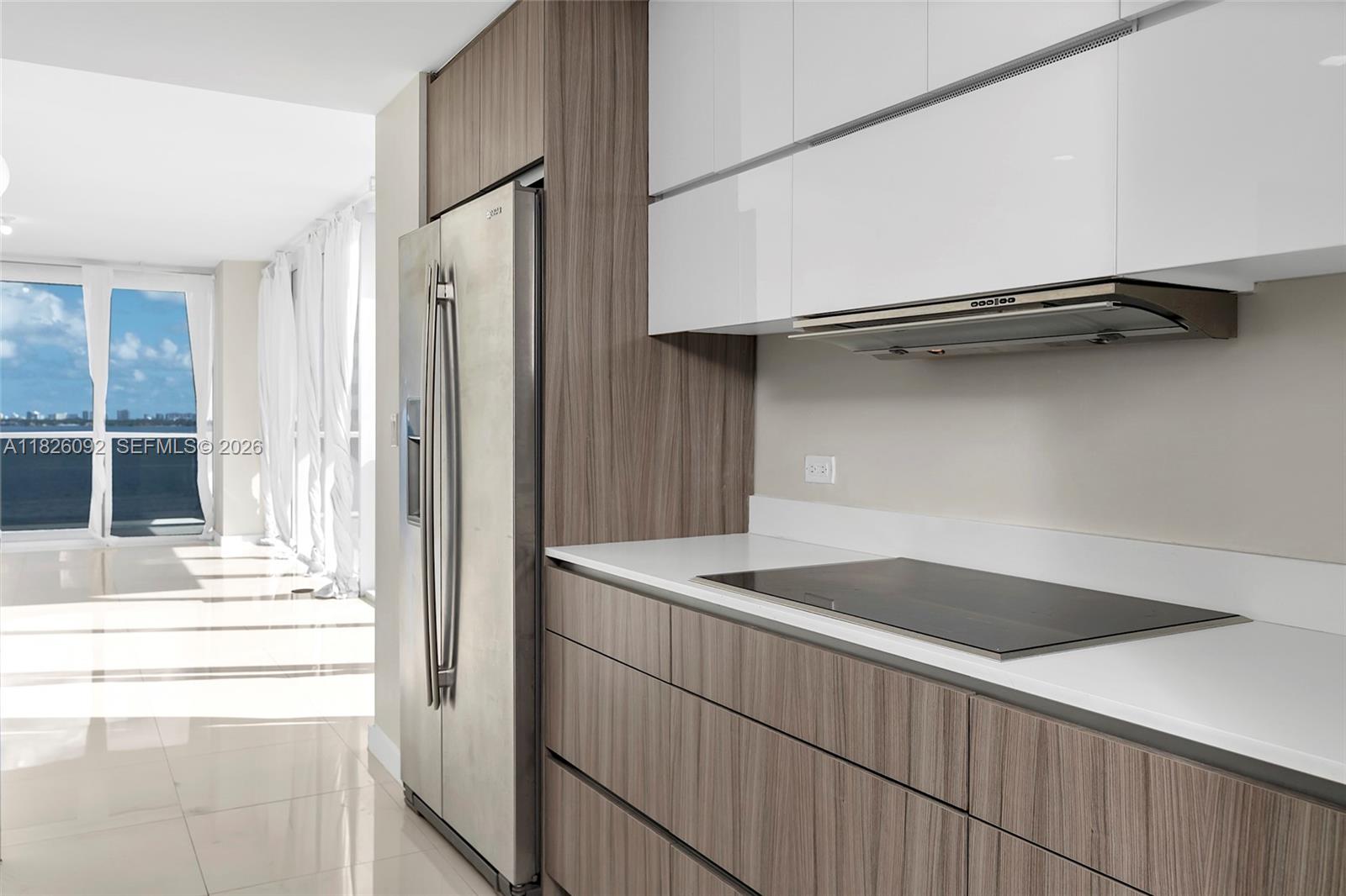 600 Northeast 27th Street, Unit 1105 Miami, FL 33137 - Photo 75 of 100 a kitchen view with a refrigerator a stove and white cabinets