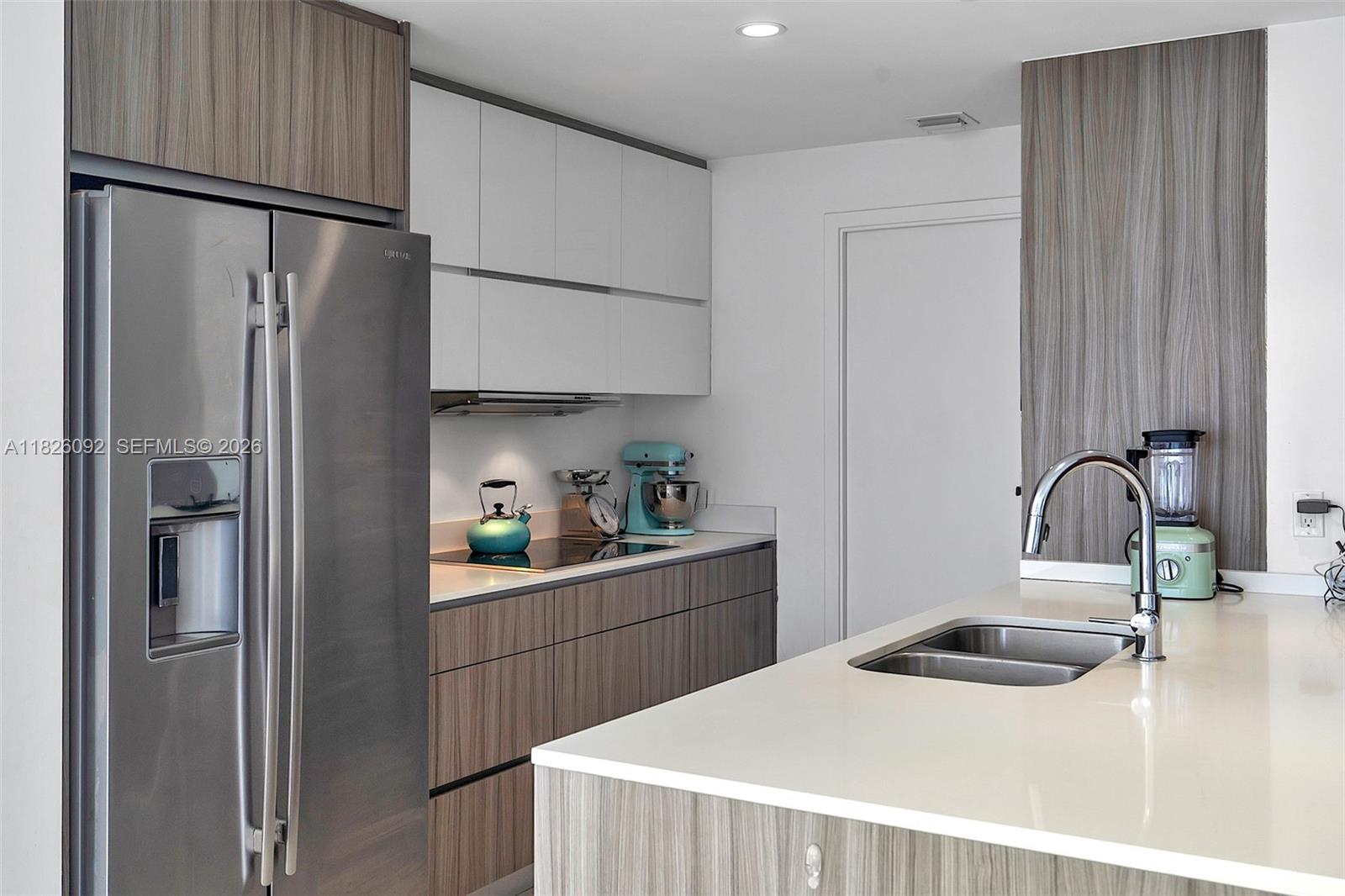 600 Northeast 27th Street, Unit 1105 Miami, FL 33137 - Photo 9 of 100 a kitchen with stainless steel appliances a refrigerator and sink