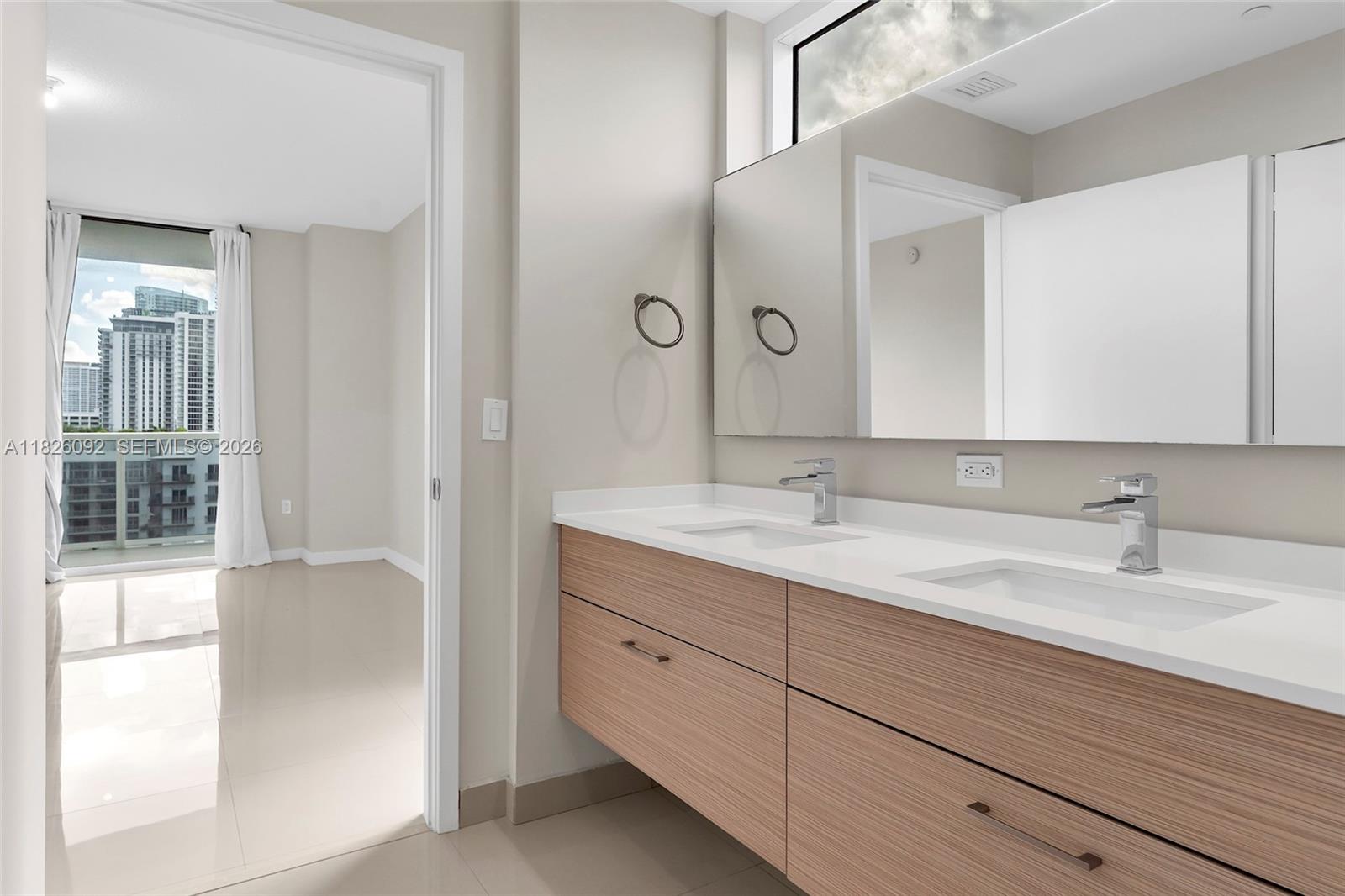 600 Northeast 27th Street, Unit 1105 Miami, FL 33137 - Photo 95 of 100 a bathroom with a double vanity sink and a mirror