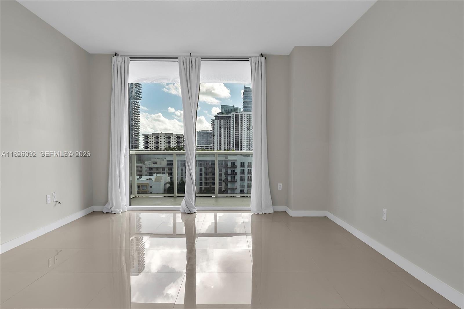 600 Northeast 27th Street, Unit 1105 Miami, FL 33137 - Photo 96 of 100 wooden floor in an empty room with a window