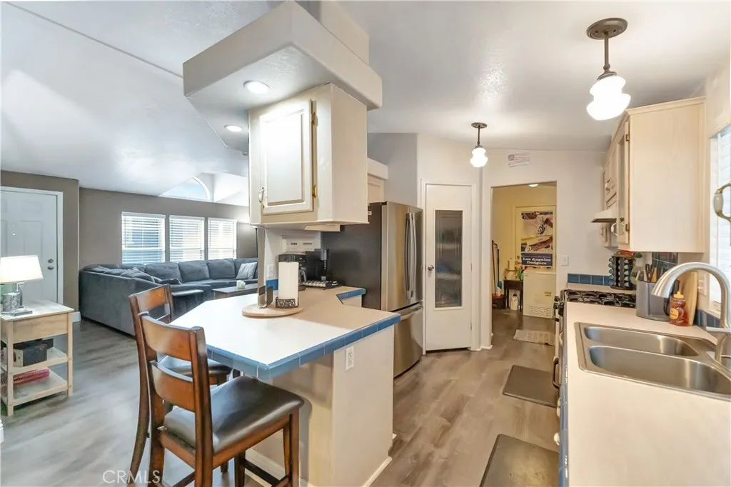1051 Site, Unit 26 Brea, CA 92821 - Photo 15 of 46 a dining room with stainless steel appliances kitchen island granite countertop a dining table chairs and a refrigerator
