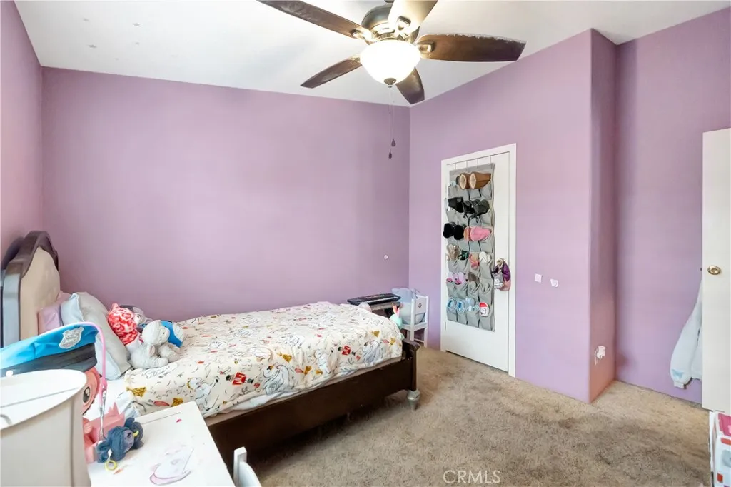 1051 Site, Unit 26 Brea, CA 92821 - Photo 26 of 46 a bedroom with a bed and a chandelier fan