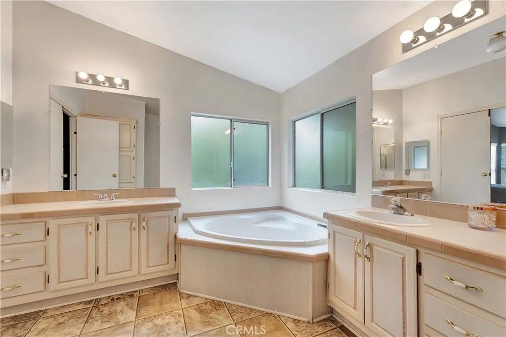 1051 Site, Unit 26 Brea, CA 92821 - Photo 31 of 46 a bathroom with a tub sink and mirror