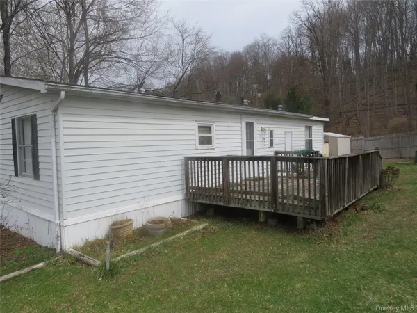 a view of a deck with a wooden fence and a yard