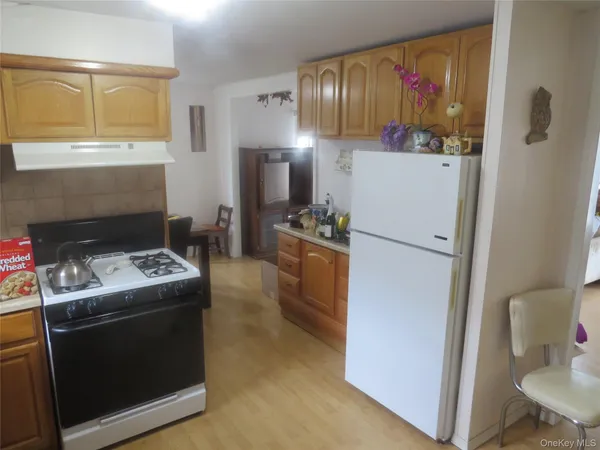 a kitchen that has a refrigerator and a stove