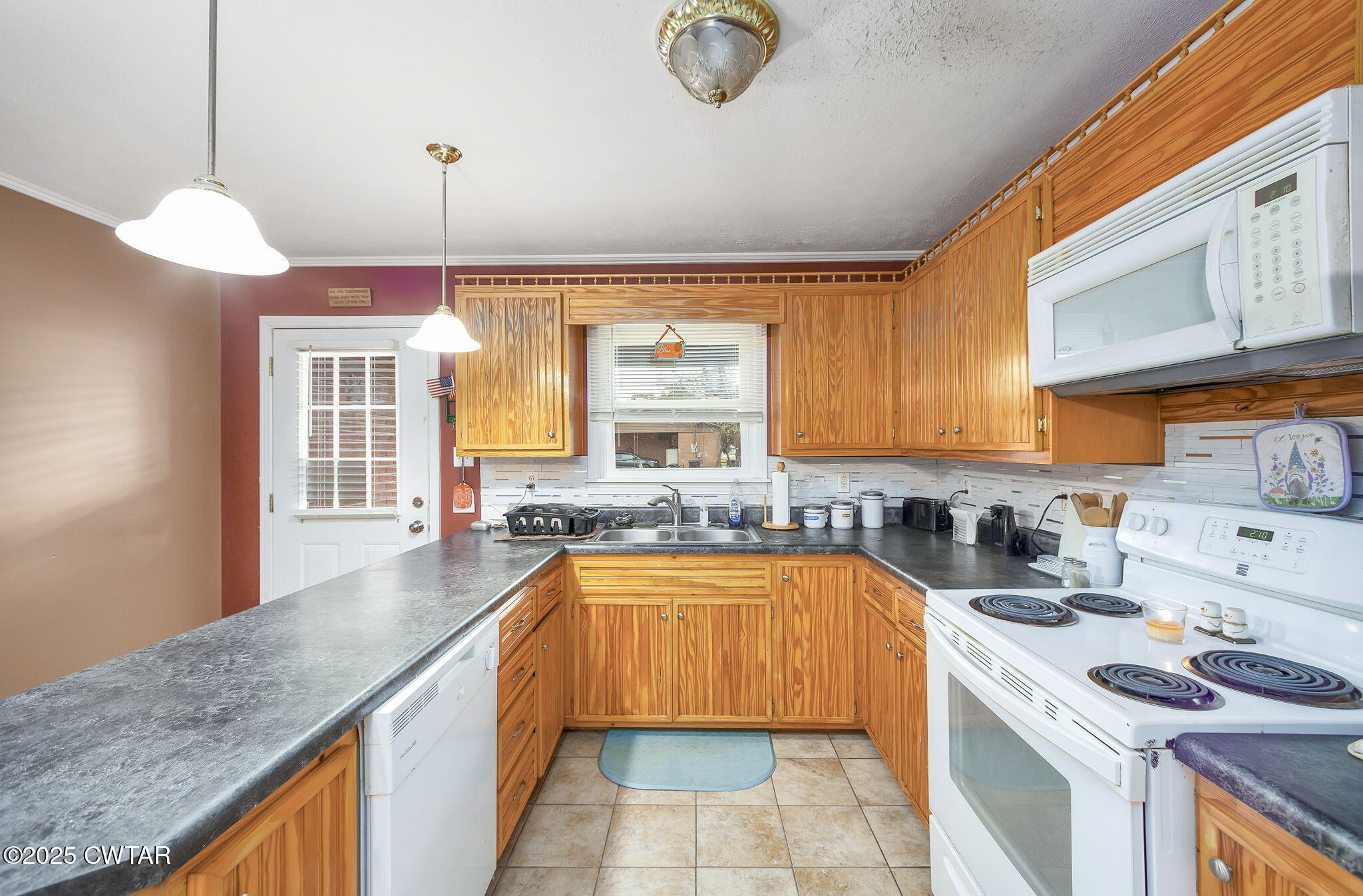 136 Mason Grove Road Humboldt, TN 38343 - Photo 18 of 36 a kitchen with a sink a stove cabinets and a window