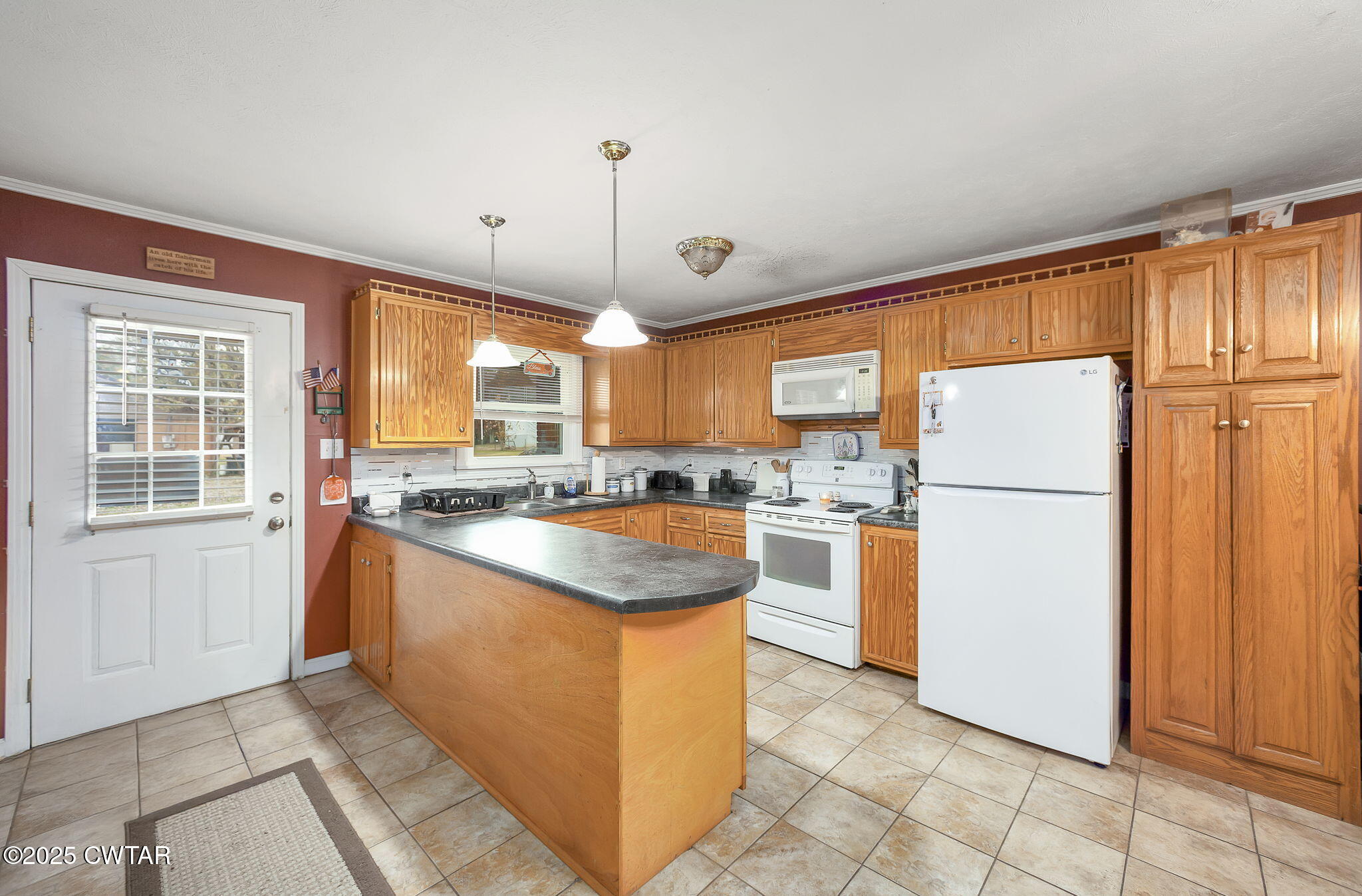 136 Mason Grove Road Humboldt, TN 38343 - Photo 19 of 36 a kitchen with refrigerator cabinets and large window
