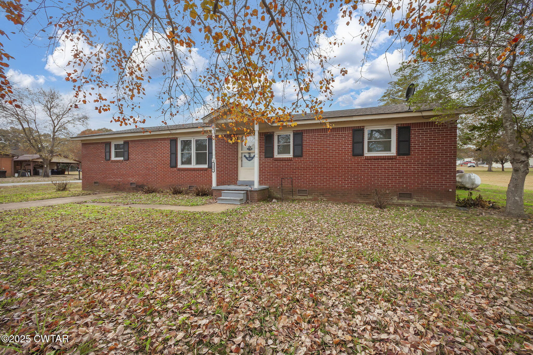 136 Mason Grove Road Humboldt, TN 38343 - Photo 2 of 36 a house that has a tree in front of it
