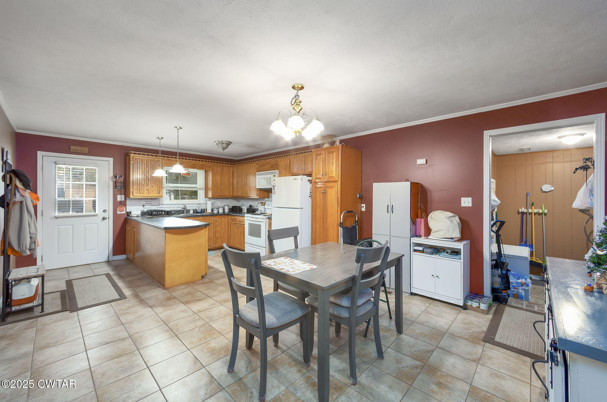 136 Mason Grove Road Humboldt, TN 38343 - Photo 21 of 36 a kitchen with a dining table chairs and refrigerator