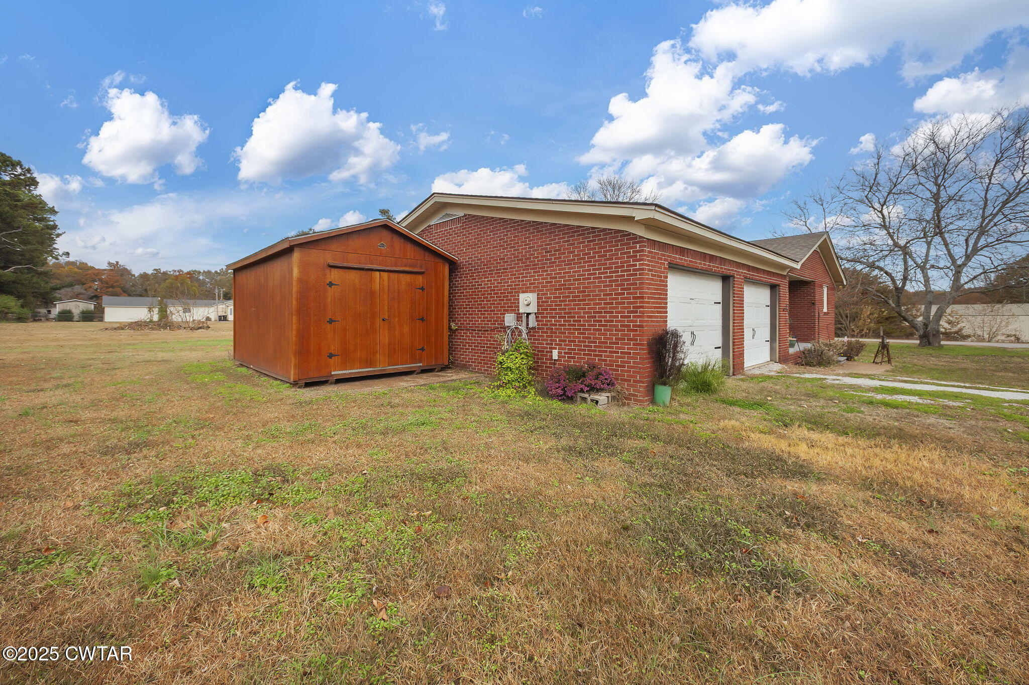 136 Mason Grove Road Humboldt, TN 38343 - Photo 5 of 36 a view of a backyard with potted plants and a large tree