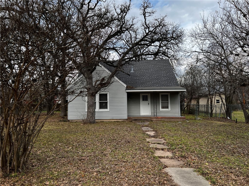 Bungalow with a shingled roof, fence, and a porch