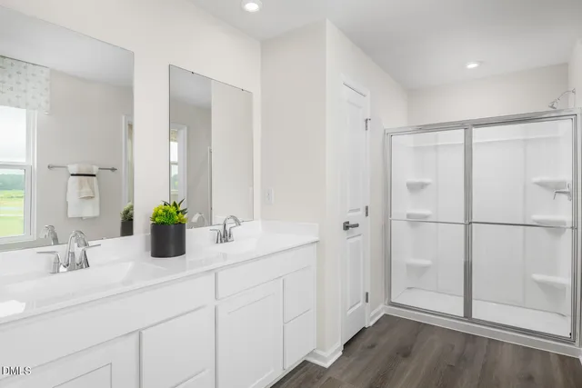 a bathroom with a double vanity sink and mirror