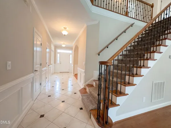 a view of entryway and hall with wooden floor