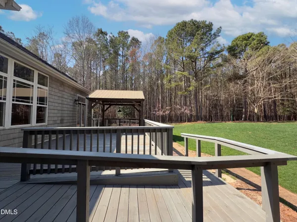 a view of a deck with mountain view and a yard