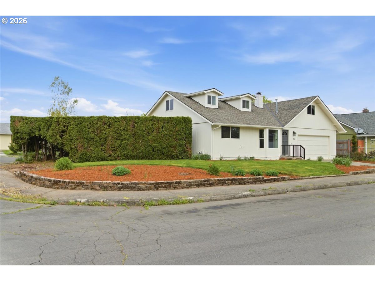 545 Baldwin Avenue Northeast Salem, OR 97301 - Photo 3 of 29 a view of a white house with a yard and potted plants
