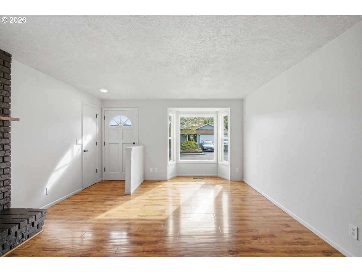 545 Baldwin Avenue Northeast Salem, OR 97301 - Photo 6 of 29 a view of a big room with wooden floor and windows