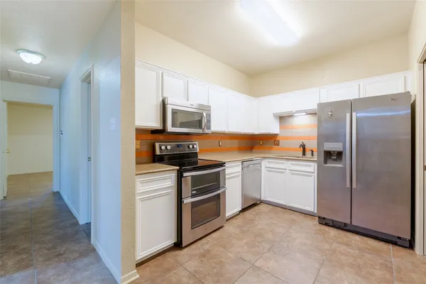 a kitchen with a refrigerator stove and microwave