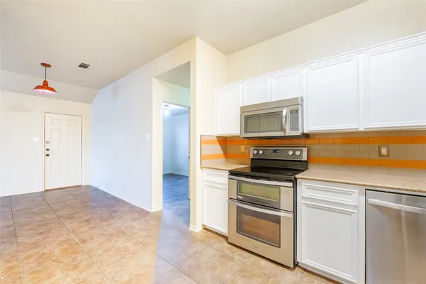 a kitchen with a stove and a microwave