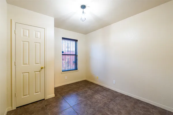 an empty room with windows and closet