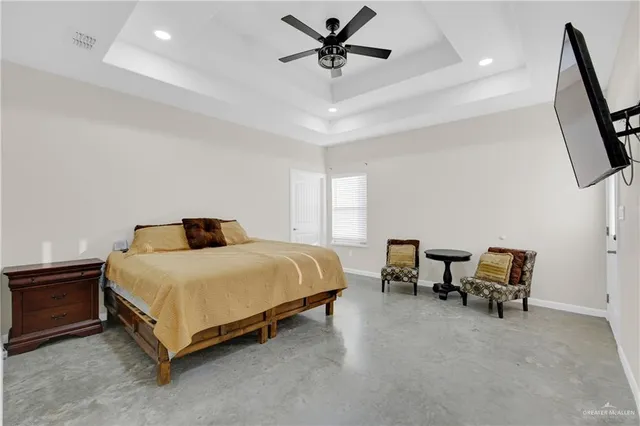 a spacious bedroom with a bed and a chair