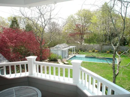 a view of a house with a yard and sitting area