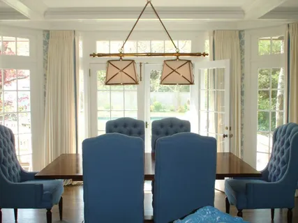 a view of a livingroom with furniture wooden floor and a floor to ceiling window