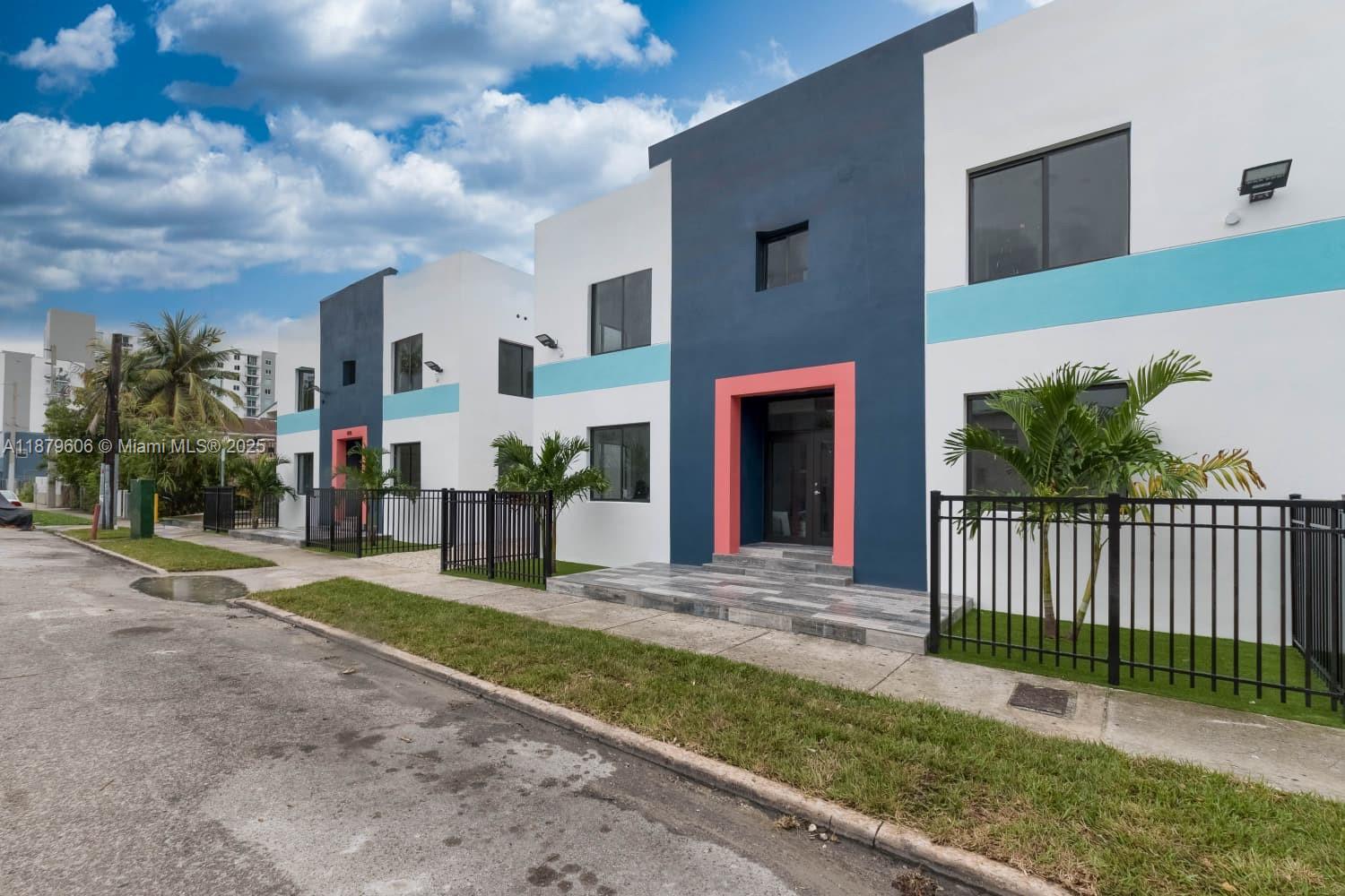 858 Northwest 3rd Street, Unit 112 Miami, FL 33128 - Photo 1 of 15 a view of a house with a yard and front of main door